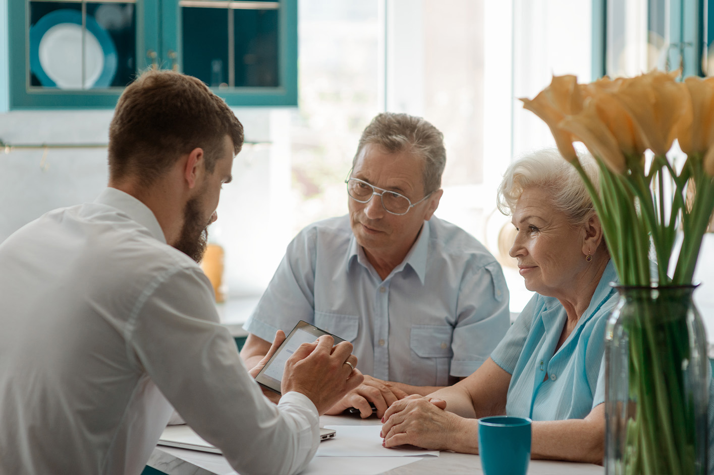 A son conversing with parents, sharing stories and exchanging smiles.